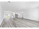 Bright and open living room with gray wood-look flooring and seamless transition to the kitchen at 3041 Sw 168Th Loop, Ocala, FL 34473