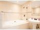 This bathroom features a tiled surround soaking tub with a pedestal sink at 3145 Packard Ave, St Cloud, FL 34772