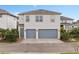 Modern two-story home with a spacious two-car garage and landscaped front yard at 7951 Nemours Pkwy, Orlando, FL 32827