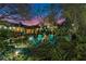 Evening view of backyard with firepit and string lights at 870 Liberty Ct, Deland, FL 32724