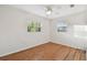 Well-lit bedroom with light wood flooring and two windows at 2141 Camellia Dr, Longwood, FL 32779