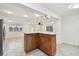 Kitchen island with wood cabinets and granite countertop at 2141 Camellia Dr, Longwood, FL 32779