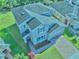Aerial view of a two-story home with a brick driveway, lush landscaping, and a well-maintained roof at 3207 Stratton Cir, Kissimmee, FL 34744