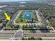 Aerial view of the real estate and surrounding community with a central lake at 3207 Stratton Cir, Kissimmee, FL 34744