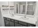 Double sink vanity with a large mirror and stylish lighting fixtures at 3207 Stratton Cir, Kissimmee, FL 34744