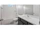 Bright bathroom with white subway tile shower over tub, dark vanity with quartz countertop, and modern fixtures at 3207 Stratton Cir, Kissimmee, FL 34744