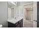 Bathroom features modern vanity, sink, and mirror with view of adjoining room and stairway at 3207 Stratton Cir, Kissimmee, FL 34744