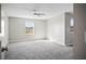 Bright bedroom features a ceiling fan, neutral paint, carpeted floor and large window at 3207 Stratton Cir, Kissimmee, FL 34744