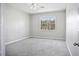 Bright bedroom with a ceiling fan, carpeted floor, and a window overlooking the trees at 3207 Stratton Cir, Kissimmee, FL 34744
