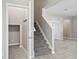 Inviting entryway featuring a carpeted staircase and tile flooring at 3207 Stratton Cir, Kissimmee, FL 34744