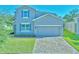 Charming two-story home with a brick driveway and manicured lawn and blue shutters at 3207 Stratton Cir, Kissimmee, FL 34744