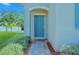 Charming home featuring a teal front door, brick walkway, and manicured lawn at 3207 Stratton Cir, Kissimmee, FL 34744