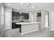 Spacious kitchen featuring a large island, dark cabinets, and modern stainless steel appliances at 3207 Stratton Cir, Kissimmee, FL 34744