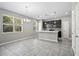 Bright kitchen and dining area featuring tile floors, ample windows and modern light fixtures at 3207 Stratton Cir, Kissimmee, FL 34744