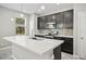 Modern kitchen with stainless steel appliances, dark cabinetry, backsplash, and a bright island at 3207 Stratton Cir, Kissimmee, FL 34744