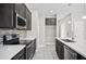 Well-equipped kitchen boasts dark cabinets, stainless appliances, and stylish backsplash at 3207 Stratton Cir, Kissimmee, FL 34744