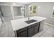 Kitchen island with a stainless steel sink overlooking the living and dining areas at 3207 Stratton Cir, Kissimmee, FL 34744