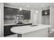 Modern kitchen featuring a large island, stainless appliances, and dark cabinetry at 3207 Stratton Cir, Kissimmee, FL 34744