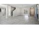 Open-concept living room with tile flooring, stairway, and abundant natural light, creating a welcoming atmosphere at 3207 Stratton Cir, Kissimmee, FL 34744
