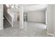 Spacious living room featuring tile flooring, stairway, and a large column, providing an open and airy feel at 3207 Stratton Cir, Kissimmee, FL 34744