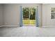 Spacious living room features gray tiling, large windows, and sliding glass doors at 3207 Stratton Cir, Kissimmee, FL 34744