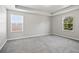 Spacious bedroom with plush carpeting, tray ceiling, and windows providing natural light at 3207 Stratton Cir, Kissimmee, FL 34744
