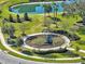 Community playground featuring a climbing structure, benches, and a scenic pond at 3207 Stratton Cir, Kissimmee, FL 34744