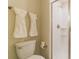 Clean bathroom featuring a toilet, towel rack, and a glass-enclosed shower with white tiles at 8943 Cabot Cliffs Dr, Davenport, FL 33896