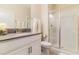 Bright bathroom features a walk-in shower, modern single vanity, and fresh flower accents at 8943 Cabot Cliffs Dr, Davenport, FL 33896