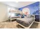 Fun ' bedroom with bunk beds, twin bed, and colorful Lion King mural on the wall at 8943 Cabot Cliffs Dr, Davenport, FL 33896
