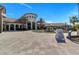 A grand clubhouse with fountain and lush landscaping provides a luxurious welcome to the community's amenities at 8943 Cabot Cliffs Dr, Davenport, FL 33896