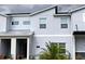 Modern townhome with neutral gray tones, a covered entryway, and a well-maintained, welcoming facade at 8943 Cabot Cliffs Dr, Davenport, FL 33896