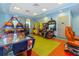 Community game room featuring arcade games, air hockey, and colorful decor, perfect for Gathering entertainment at 8943 Cabot Cliffs Dr, Davenport, FL 33896