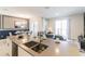 Kitchen island view showing open-concept living and dining areas, perfect for entertaining guests at 8943 Cabot Cliffs Dr, Davenport, FL 33896