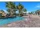 A serene lazy river winds through lush palm trees, offering a tranquil escape with resort-style amenities at 8943 Cabot Cliffs Dr, Davenport, FL 33896