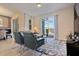 Inviting living room featuring comfortable seating, stylish decor, and natural light from sliding doors at 8943 Cabot Cliffs Dr, Davenport, FL 33896