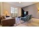Comfortable living room with a modern sofa, stylish chairs, and access to an outdoor patio at 8943 Cabot Cliffs Dr, Davenport, FL 33896