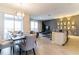 Open-concept living space featuring a dining area, living room, and a modern kitchen at 8943 Cabot Cliffs Dr, Davenport, FL 33896