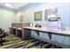Office area with multiple workspaces, modern decor, printer and bright lighting at 8943 Cabot Cliffs Dr, Davenport, FL 33896