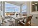 The cozy outdoor dining area presents a delightful setting for meals, overlooking serene views for relaxed enjoyment at 8943 Cabot Cliffs Dr, Davenport, FL 33896