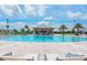A sparkling pool features a swim-up bar and plenty of lounge chairs for relaxation on a sunny day at 8943 Cabot Cliffs Dr, Davenport, FL 33896