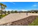 The spacious sand volleyball court is perfect for friendly competition and outdoor enjoyment with Gathering and friends at 8943 Cabot Cliffs Dr, Davenport, FL 33896