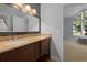 Double vanity bathroom with granite countertops and a mirror at 2115 Lake Crescent Ct, Windermere, FL 34786