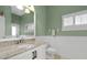 Charming bathroom boasts a granite countertop, updated vanity, and a relaxing color scheme at 2115 Lake Crescent Ct, Windermere, FL 34786