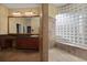 Elegant bathroom with a large walk-in shower and glass block wall at 2115 Lake Crescent Ct, Windermere, FL 34786