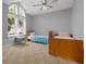 Charming bedroom with two twin beds and an arched window at 2115 Lake Crescent Ct, Windermere, FL 34786