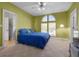 Bright bedroom with a blue bed and leafy decor at 2115 Lake Crescent Ct, Windermere, FL 34786
