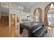 Game room with pool table, hardwood floors, and access to kitchen and backyard at 2115 Lake Crescent Ct, Windermere, FL 34786
