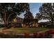 Elegant two-story home with landscaping at dusk at 2115 Lake Crescent Ct, Windermere, FL 34786