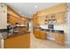 Kitchen with granite countertops, light wood cabinets, and built-in desk area at 2115 Lake Crescent Ct, Windermere, FL 34786
